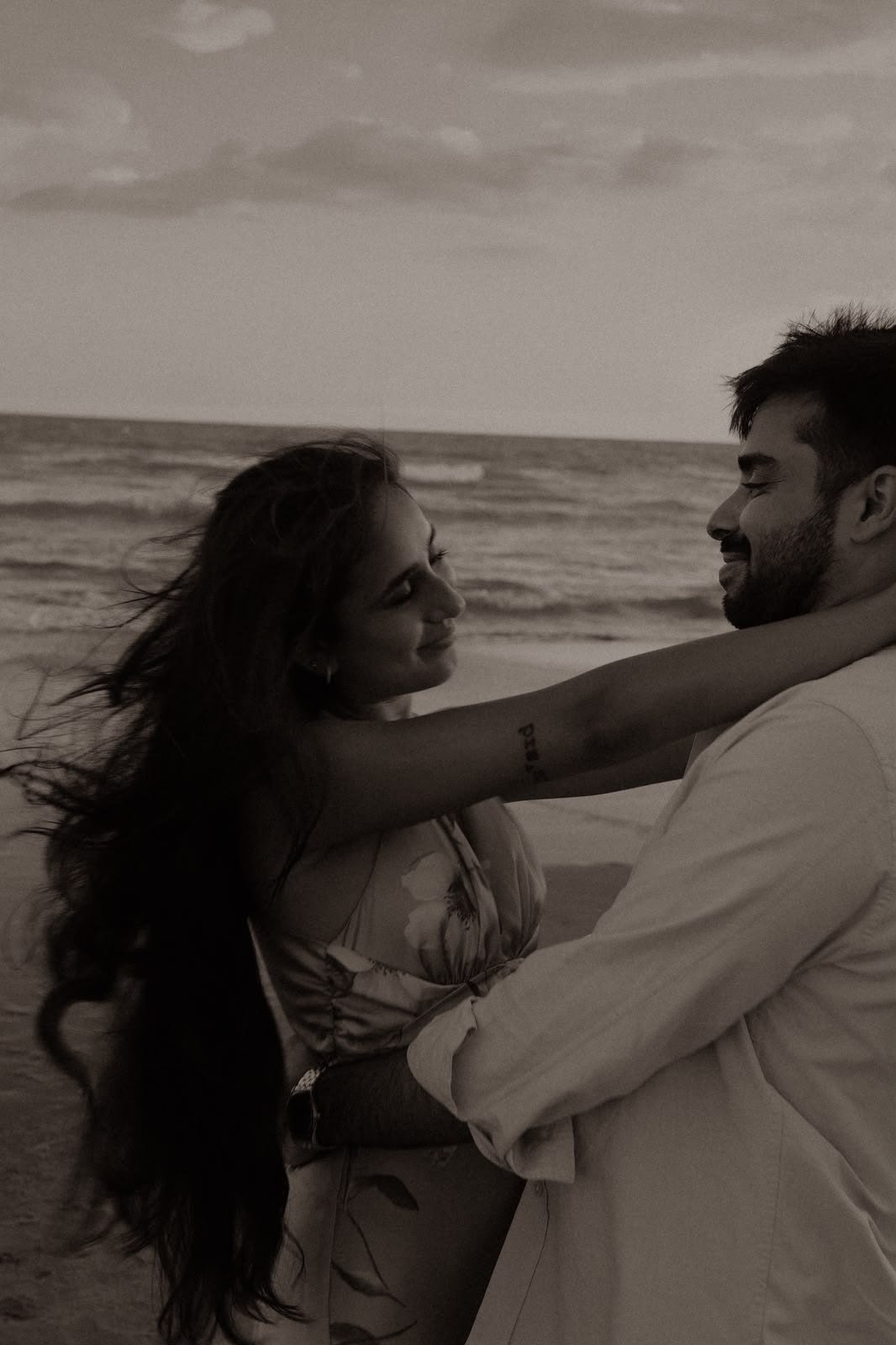 Sindhu and Amish embracing on the beach