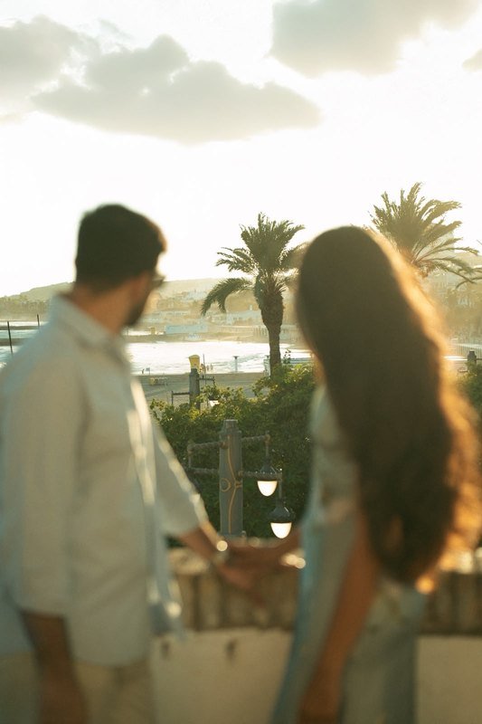 Sindhu and Amish on a terrace with palm trees